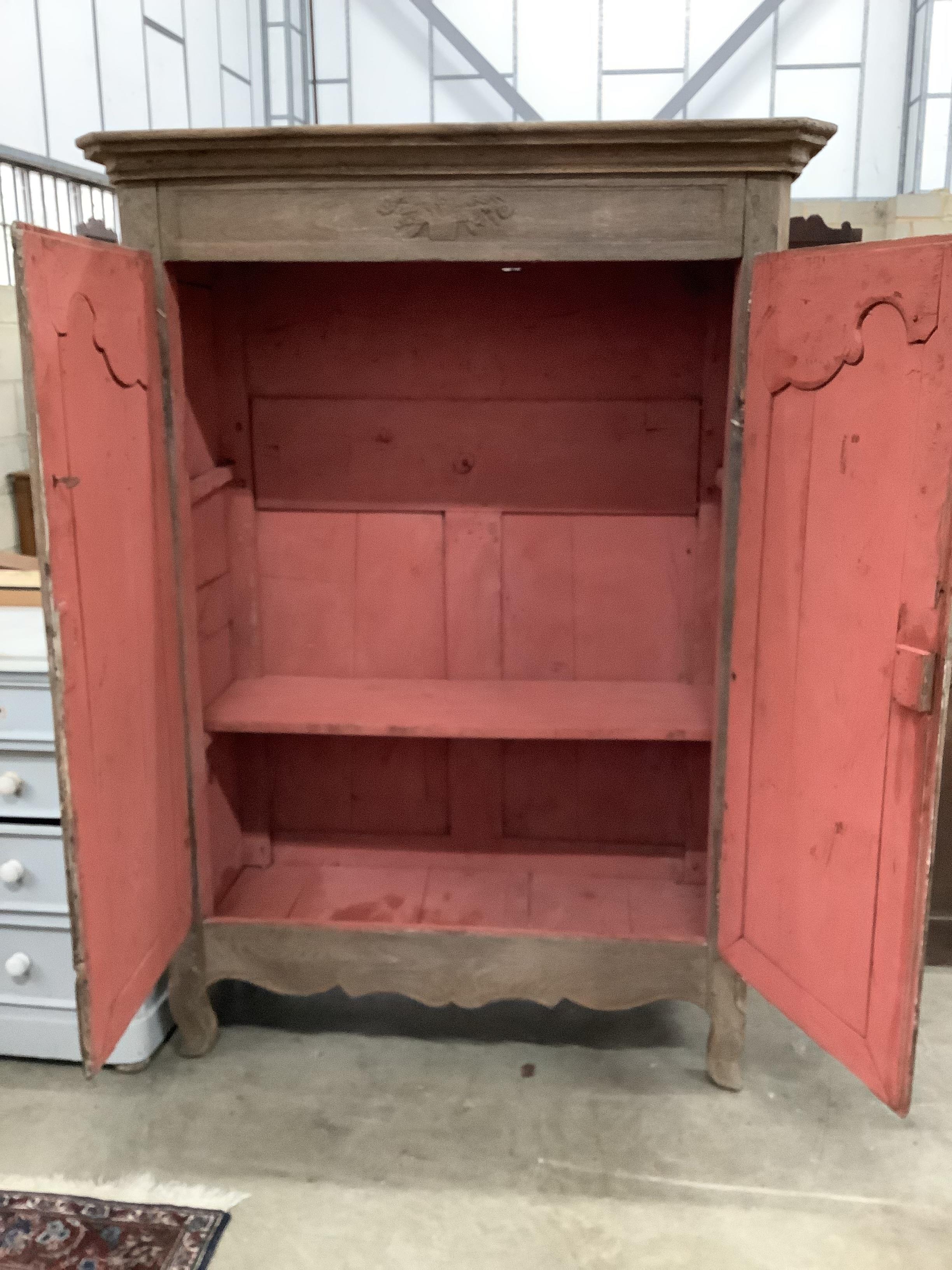 A 19th century French oak two door cupboard with painted interior, width 117cm, depth 55cm, height 162cm